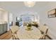 Bright dining area with marble table, decorative lighting, and a view to the living room at 298 Pinehurst Ln. # 10-J, Pawleys Island, SC 29585