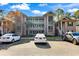 Condominium exterior showcasing well-maintained grounds and convenient parking spaces at 298 Pinehurst Ln. # 10-J, Pawleys Island, SC 29585
