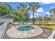 A luxurious hot tub surrounded by brick pavers, palm trees, and resort-style amenities at 298 Pinehurst Ln. # 10-J, Pawleys Island, SC 29585