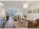 Bright living room featuring vaulted ceilings, hardwood floors, a dining area and a comfortable seating area with a balcony at 298 Pinehurst Ln. # 10-J, Pawleys Island, SC 29585