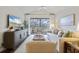 Bright living area with vaulted ceilings, balcony access, and modern decor at 298 Pinehurst Ln. # 10-J, Pawleys Island, SC 29585