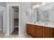 Bathroom with double vanity sinks, wood cabinets, and closet creating a practical and stylish space at 301 Barlow Ct., Conway, SC 29526