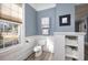 Bathroom featuring a toilet, built-in shelves, and a window providing plenty of natural light at 309 W Bond St., Marion, SC 29571