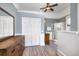 Bright bathroom with light blue walls, white trim, wood-look floors, double closet, and a glass-enclosed shower at 309 W Bond St., Marion, SC 29571