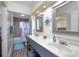 Bright bathroom with a double sink vanity, tile shower, and light-colored walls at 309 W Bond St., Marion, SC 29571