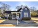 Beautiful blue home with a classic white porch and manicured lawn at 309 W Bond St., Marion, SC 29571