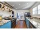Well-lit kitchen with blue cabinets, stainless steel appliances and granite countertops at 309 W Bond St., Marion, SC 29571