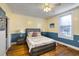 Bright main bedroom with wood floors, ceiling fan, stylish decor, and plenty of natural light at 309 W Bond St., Marion, SC 29571