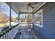 Covered front porch with hanging swing chairs and views of the neighborhood at 309 W Bond St., Marion, SC 29571