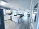 Open-concept living space with modern lighting, hardwood floors, and updated kitchen at 330 Kiskadee Loop # A, Conway, SC 29526