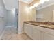 Primary bathroom featuring double sink vanity, granite countertops, white cabinets, and decorative lighting at 3304 Palm St., North Myrtle Beach, SC 29582