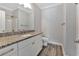Bathroom featuring a white vanity with granite countertop, a framed mirror, and modern fixtures at 3304 Palm St., North Myrtle Beach, SC 29582