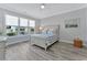 Bedroom showcasing a large window, a queen bed with blue and white bedding, and modern flooring at 3304 Palm St., North Myrtle Beach, SC 29582