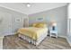 Bright bedroom featuring a queen bed with yellow accents, complemented by a matching side table and stylish decor at 3304 Palm St., North Myrtle Beach, SC 29582