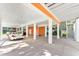 Spacious covered parking area featuring multiple support pillars, a white car, and convenient access to stairs at 3304 Palm St., North Myrtle Beach, SC 29582