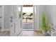 Inviting entryway showcasing an open door with neighborhood views, a stylish wood floor, and a decorative plant at 3304 Palm St., North Myrtle Beach, SC 29582