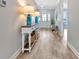 Inviting foyer with attractive flooring, console table with decor and natural light streaming through the front door at 3304 Palm St., North Myrtle Beach, SC 29582