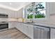 Modern kitchen featuring stainless steel appliances, granite countertops, white cabinets and a window with a lovely view at 3304 Palm St., North Myrtle Beach, SC 29582