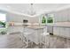 Bright kitchen with white cabinets, granite countertops, stainless steel appliances, large island and chandelier lighting at 3304 Palm St., North Myrtle Beach, SC 29582