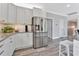 Contemporary kitchen with stainless steel appliances, granite countertops, white cabinets, and modern flooring at 3304 Palm St., North Myrtle Beach, SC 29582