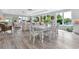 Bright and airy living and dining area with large windows, modern furniture, and wood-style flooring at 3304 Palm St., North Myrtle Beach, SC 29582