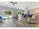 Spacious living room with lots of seating, fan and sliding glass doors leading to a deck at 3304 Palm St., North Myrtle Beach, SC 29582