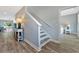 Hallway featuring a modern staircase, stylish console table, and a peek into a sunny bedroom at 3304 Palm St., North Myrtle Beach, SC 29582