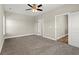 Spacious bedroom with plush carpeting, a ceiling fan, and access to a private ensuite bathroom at 344 Kiskadee Loop # A, Conway, SC 29526