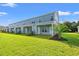 View of the townhome with blue siding and manicured lawn at 344 Kiskadee Loop # A, Conway, SC 29526