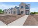 New townhomes displaying light brick and blue siding, complemented by pristine sidewalks under a clear sky at 344 Kiskadee Loop # B, Conway, SC 29526