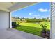 View from a covered back patio overlooking the green yard and pond at 344 Kiskadee Loop # B, Conway, SC 29526