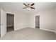Spacious bedroom featuring neutral carpet, ceiling fan, and walk-in closet entrance at 344 Kiskadee Loop # C, Conway, SC 29526