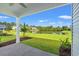 The back porch offers views of a lush green lawn and a tranquil pond in a nature-filled area at 344 Kiskadee Loop # E, Conway, SC 29526