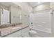 Bright bathroom featuring granite countertops, white vanity, mirror and a shower-tub combination at 344 Kiskadee Loop # E, Conway, SC 29526