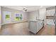 Bright kitchen with granite island, white cabinets, stainless steel dishwasher, and sliding glass door to outside at 344 Kiskadee Loop # E, Conway, SC 29526