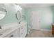 Bathroom featuring dual sinks with white cabinets, tile flooring, neutral walls, and vanity lighting at 3516 Queens Harbour Blvd., Myrtle Beach, SC 29588