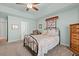 Bedroom with carpeting, ceiling fan, natural light, and a quilt hanging above an iron bed frame at 3516 Queens Harbour Blvd., Myrtle Beach, SC 29588