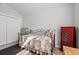 Cozy bedroom features a daybed with a colorful patchwork quilt and red cabinet at 3516 Queens Harbour Blvd., Myrtle Beach, SC 29588
