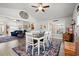 Inviting dining room boasts vaulted ceilings, neutral walls, ceiling fan, and views into an open living room at 3516 Queens Harbour Blvd., Myrtle Beach, SC 29588