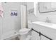 Bathroom featuring a marble tiled shower, white vanity, and shiplap walls at 3530 Reavis Ln., Myrtle Beach, SC 29579