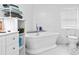 Cozy bathroom featuring a free-standing tub, toilet, and storage shelves with fresh towels and toiletries at 3530 Reavis Ln., Myrtle Beach, SC 29579