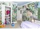 bedroom featuring safari themed wallpaper, light colored walls, and a fun closet at 3530 Reavis Ln., Myrtle Beach, SC 29579