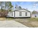 Exterior of home showcasing neat, white siding and black trim, and a large yard at 3530 Reavis Ln., Myrtle Beach, SC 29579