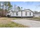 Charming single-story home with a black and white exterior and spacious concrete driveway at 3530 Reavis Ln., Myrtle Beach, SC 29579