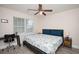 Bedroom with desk, ceiling fan, and queen-size bed with blue bedding at 3952 Murrells Inlet Rd., Murrells Inlet, SC 29576