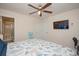 Bedroom with shell bedding, TV, ceiling fan, and access to ensuite bathroom at 3952 Murrells Inlet Rd., Murrells Inlet, SC 29576