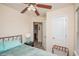 Comfortable bedroom with a ceiling fan, ensuite bathroom and light-colored walls at 3952 Murrells Inlet Rd., Murrells Inlet, SC 29576