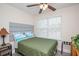 Bedroom with window, ceiling fan, and queen bed with green quilt at 3952 Murrells Inlet Rd., Murrells Inlet, SC 29576