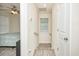Hallway with a view of the bedroom featuring natural light, fan, and neutral walls at 3952 Murrells Inlet Rd., Murrells Inlet, SC 29576