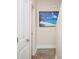 Hallway with wood floors and beach-themed artwork adds coastal charm to the home at 3952 Murrells Inlet Rd., Murrells Inlet, SC 29576